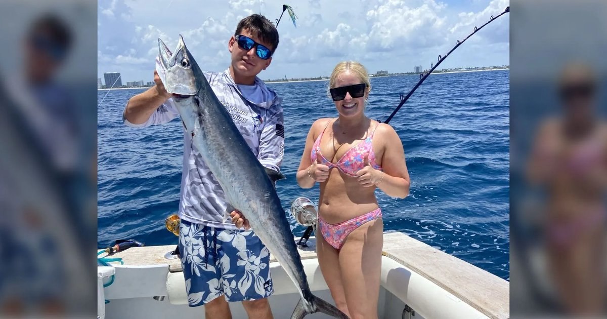 Guests holding a wahoo on a Don’t Panic Sportfishing trip