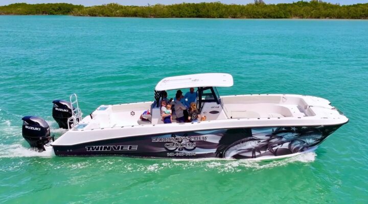 Harrison's Chew Charters website photo of a boat cruising beside a tropical island