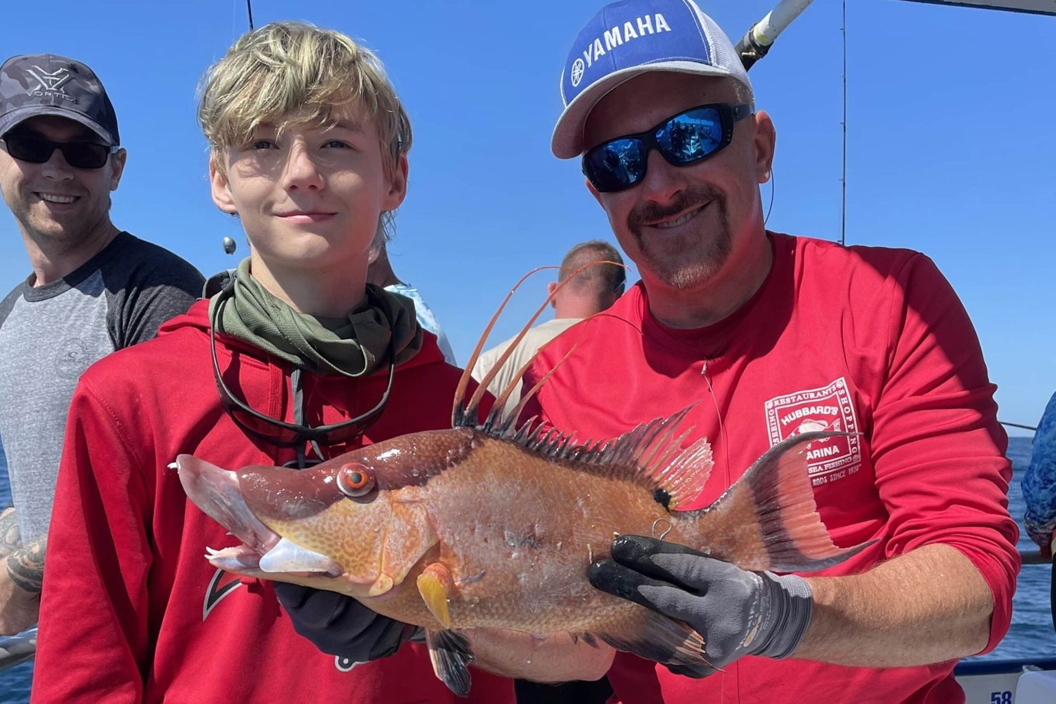 Hubbards Marina young angler and crew member holding a hogfish