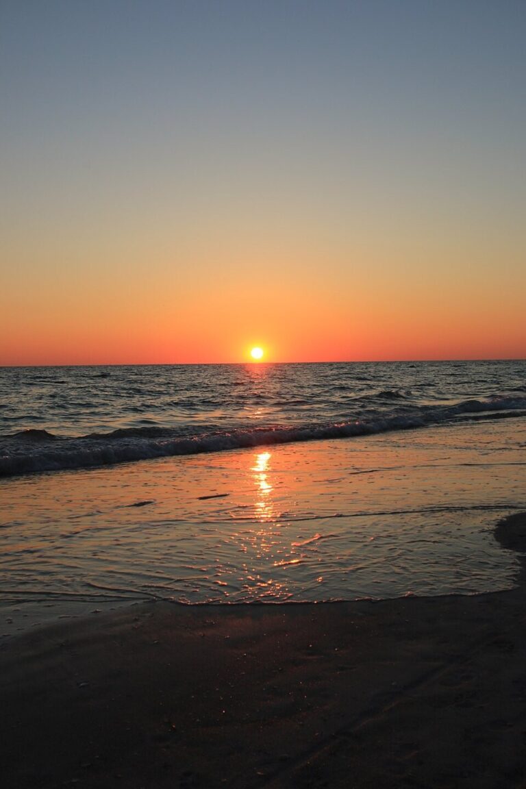 Orange sunset reflected in the Gulf wash at Holmes Beach in May 2016