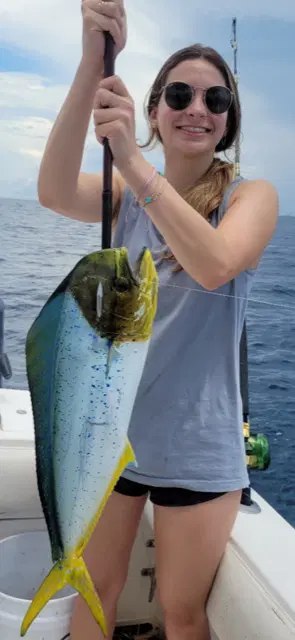 ICX Charters young guest showing a mahi catch