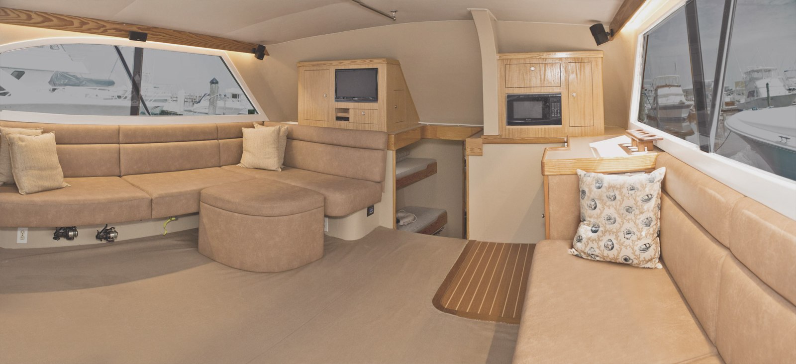 J-Hook sportfishing boat salon with sofa seating and galley