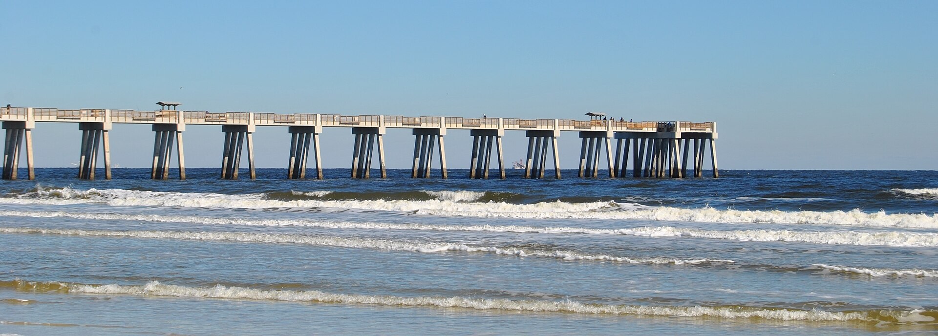 Jacksonville Beach Fishing Pier extending over Atlantic waves