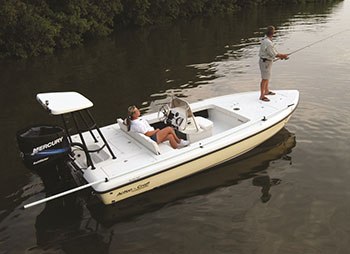 Jacksonville Fishing Trips boat beside a wooded shoreline