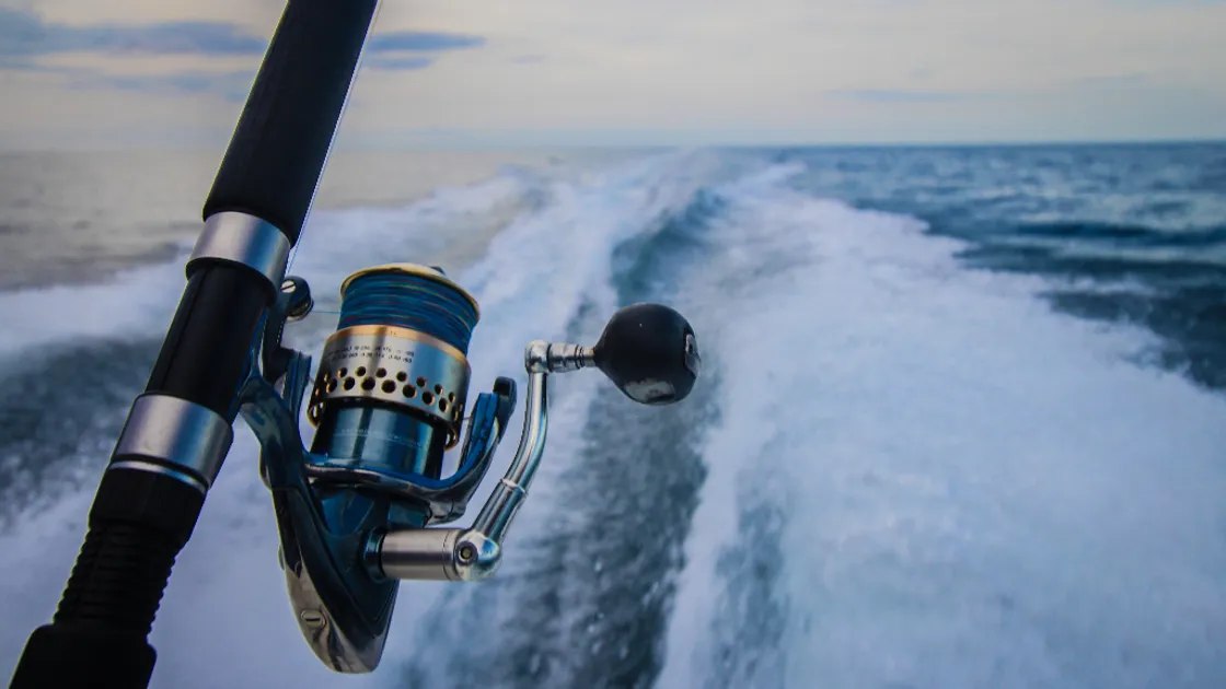King Charters website photo of a spinning reel beside a boat wake