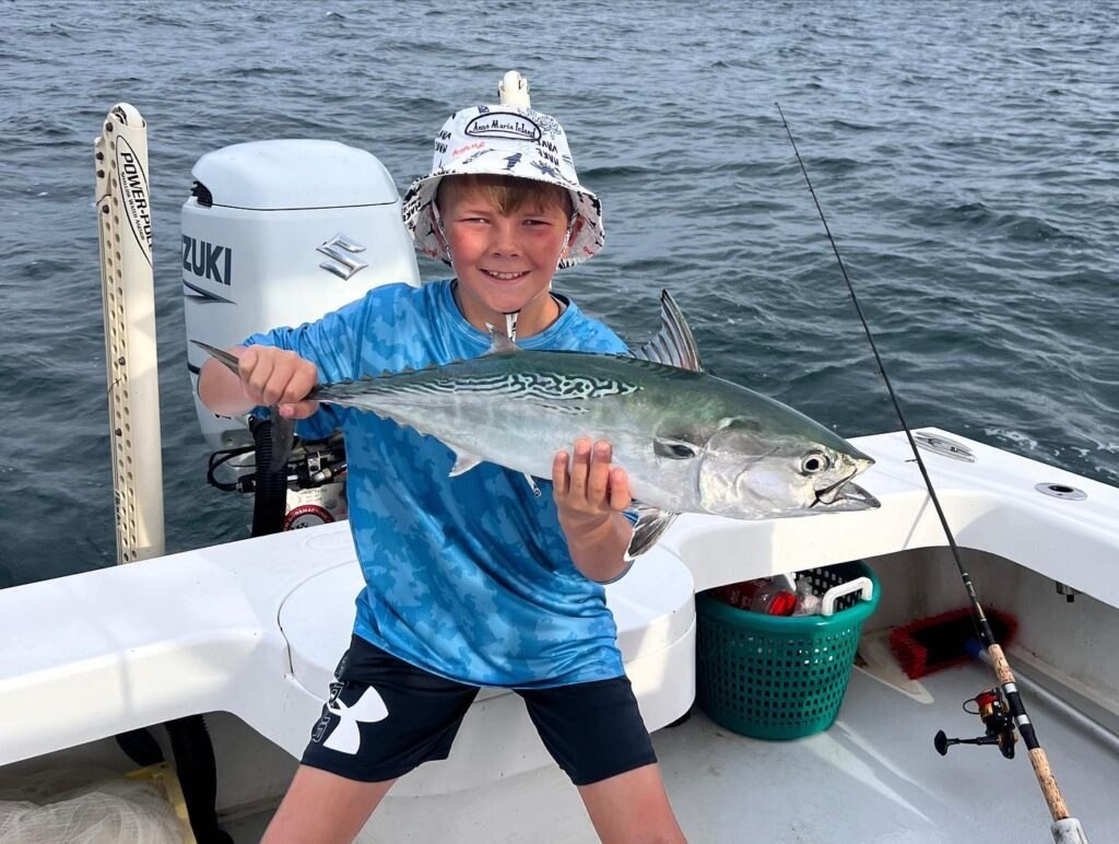 Gulfcart Charters young angler holding a king mackerel