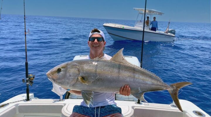 Lucky Hook angler holding a jack crevalle