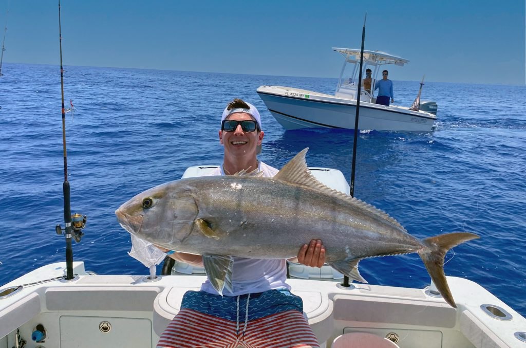 Lucky Hook angler holding a jack crevalle