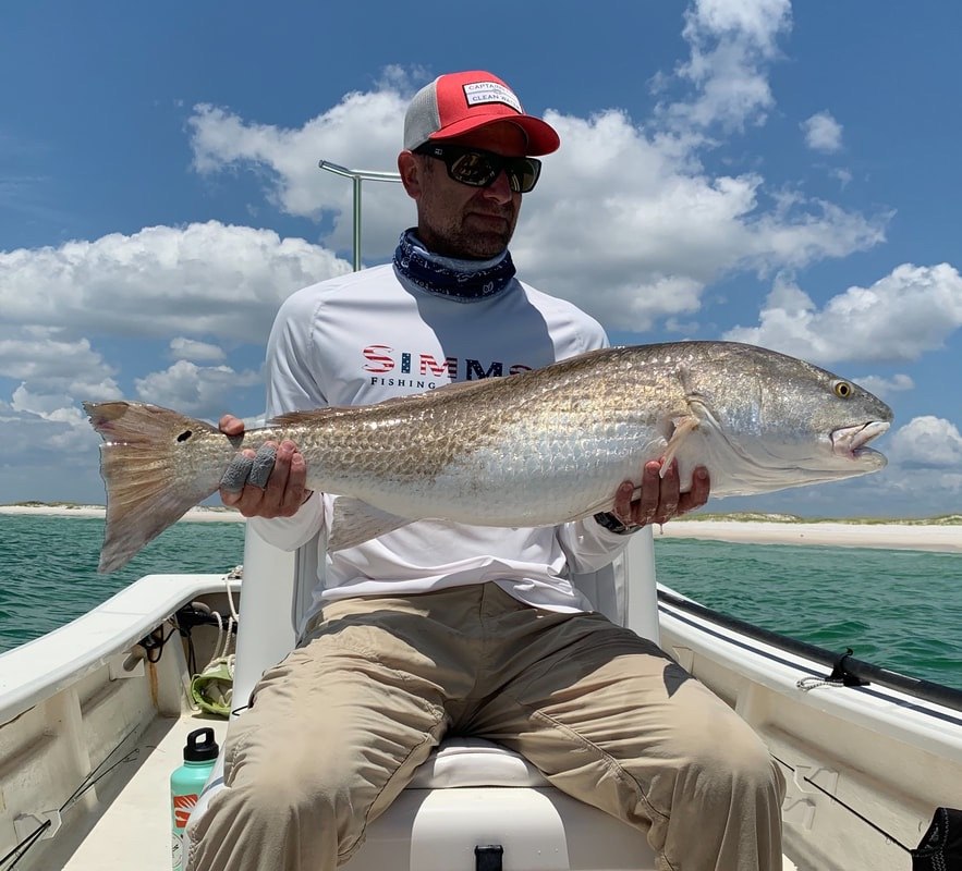LuckyFly Charters guest displaying a spotted seatrout