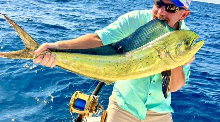 Marlin My Darlin angler holding a mahi mahi