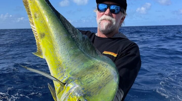 Miss Britt angler holding a mahi mahi