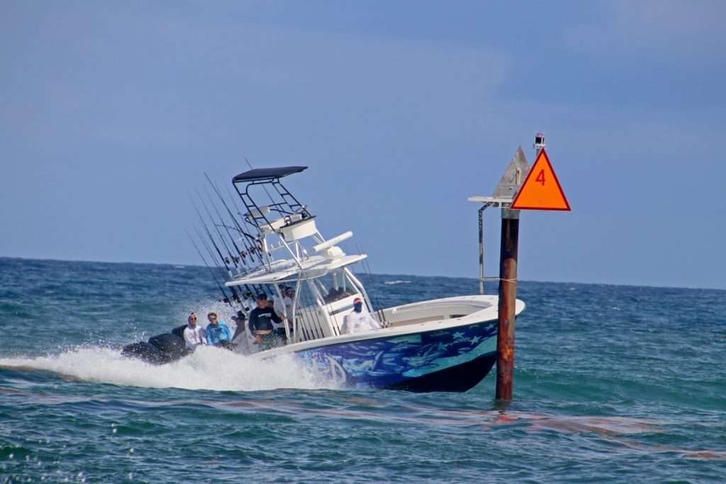 O-Sea-D sportfishing boat passing an inlet channel marker