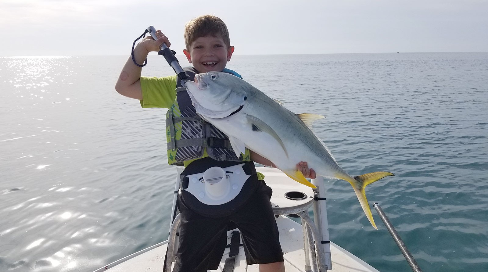 Orlando Fishing Charters young angler holding a jack crevalle
