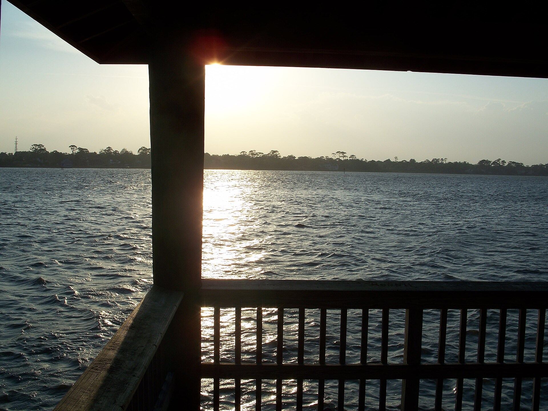 Sunlight over the Halifax River seen through a waterfront pavilion in Ormond Beach