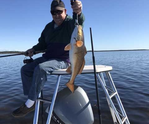 OTF Inshore Charters angler holding a fish on the bow
