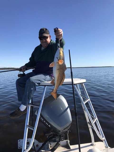 OTF Inshore Charters angler holding a fish on the bow
