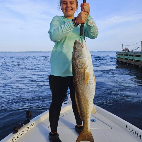 Panhandle Fishing Charters guest holding a redfish