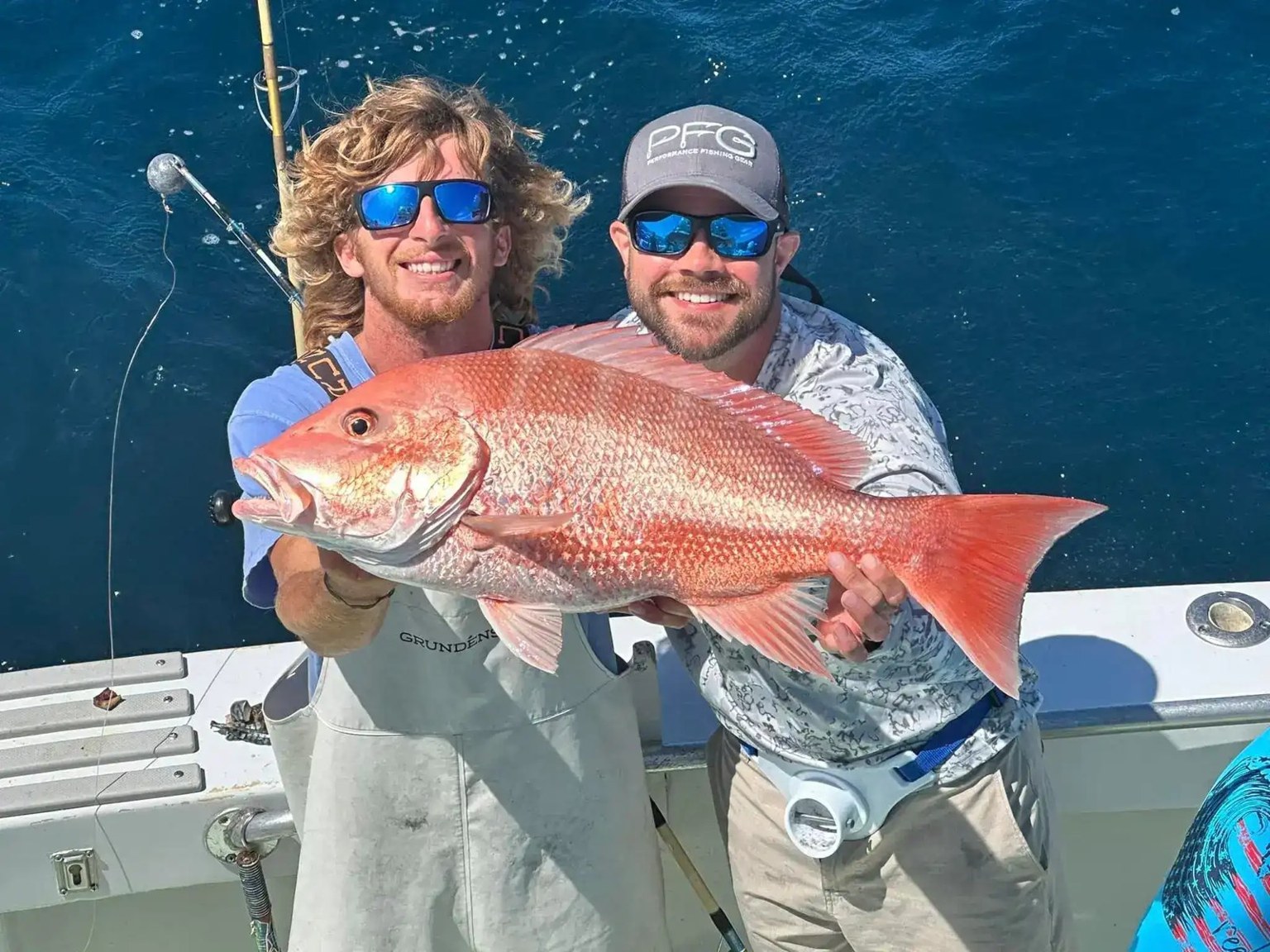 Anglers holding red snapper