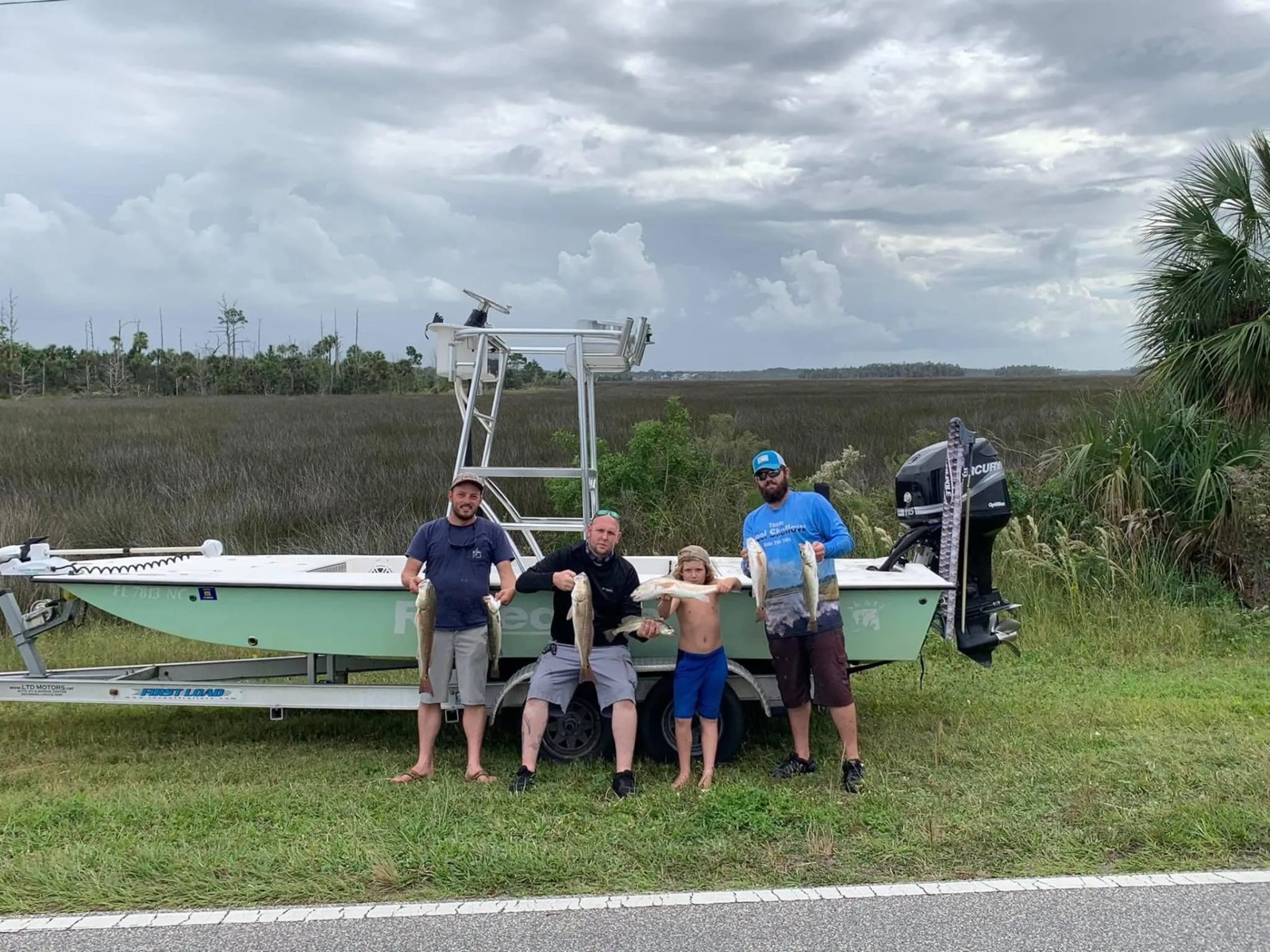 Reel Shallow Fishn group standing beside a trailered fishing boat