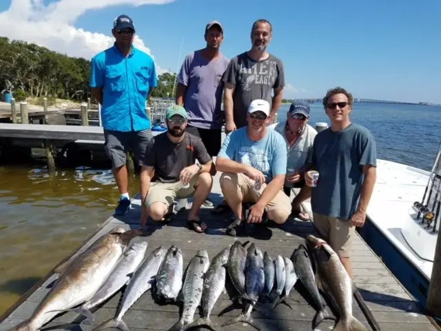 Reel Way fishing guests with their catch aboard the boat