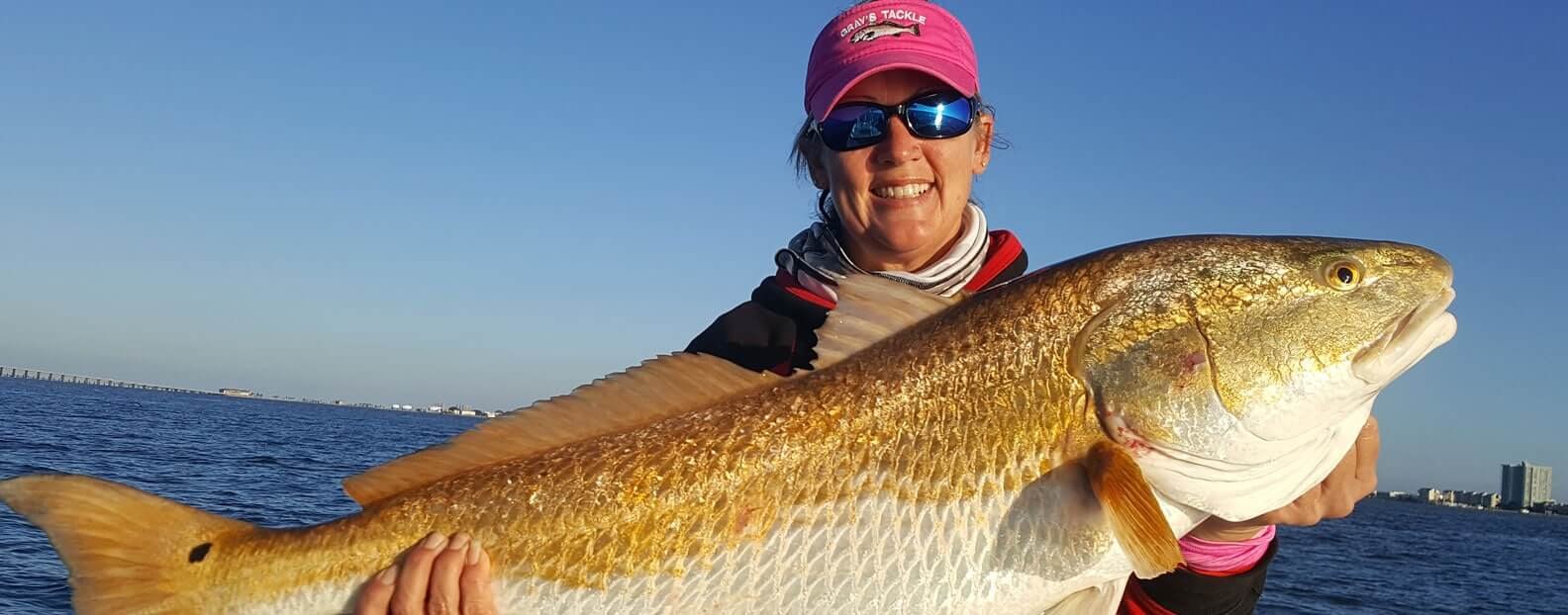 Rock Bottom Charters angler displaying a large redfish