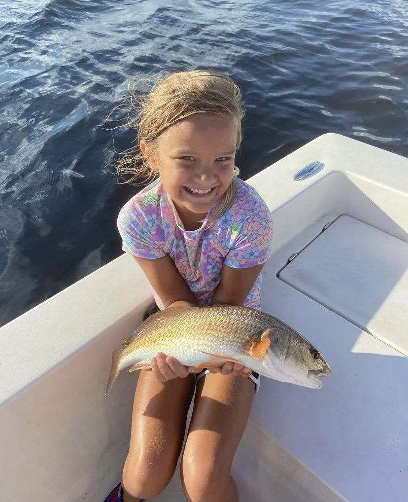 Salt Obsession young angler holding a spotted seatrout