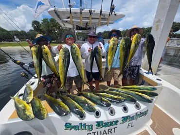 Salty Daze anglers holding mahi across the boat stern