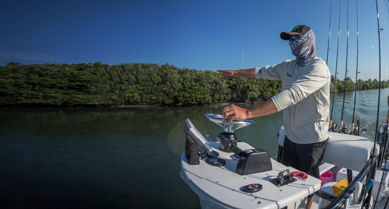 Seeing Spots Charters angler casting from a bay boat