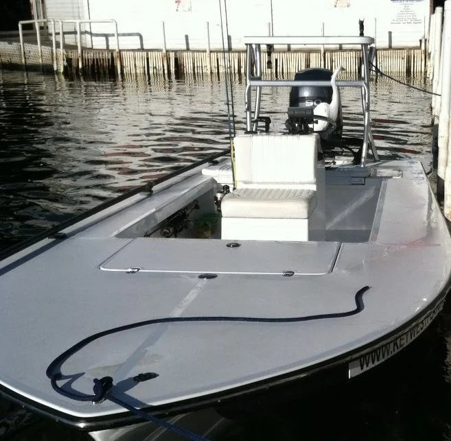 Shallow-water fishing skiff at a dock