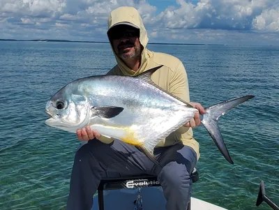 Simply Fly angler holding a permit