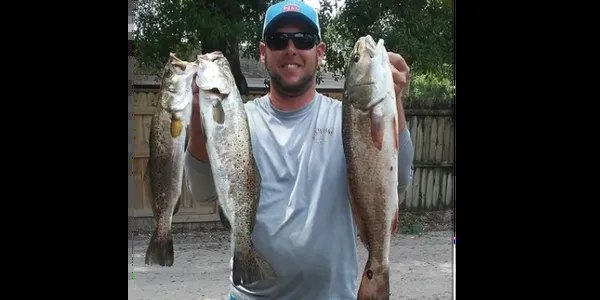 Skinnin Fins angler displaying two spotted seatrout