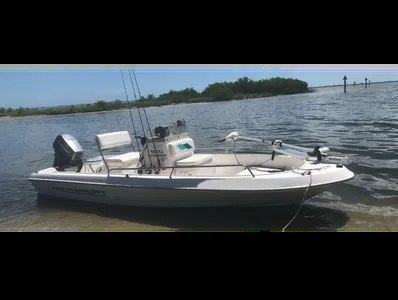 Space Coast Fishing Charters skiff beside the Titusville shoreline