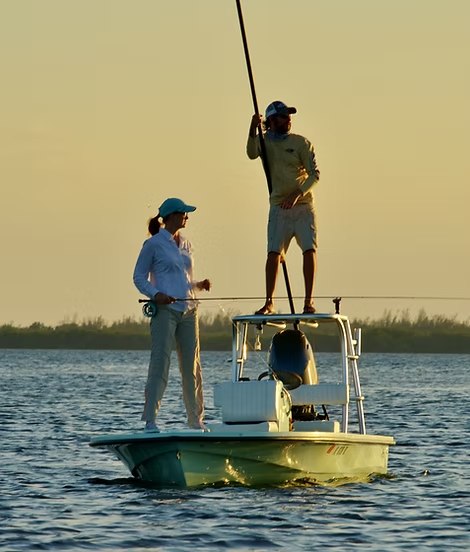 Spirit Fly Charters guide poling a skiff while an angler casts