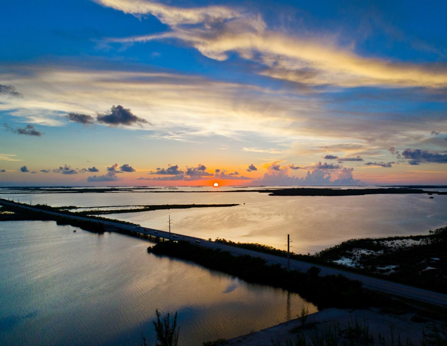 Sunset over a bridge and coastal water at Sugarloaf Key