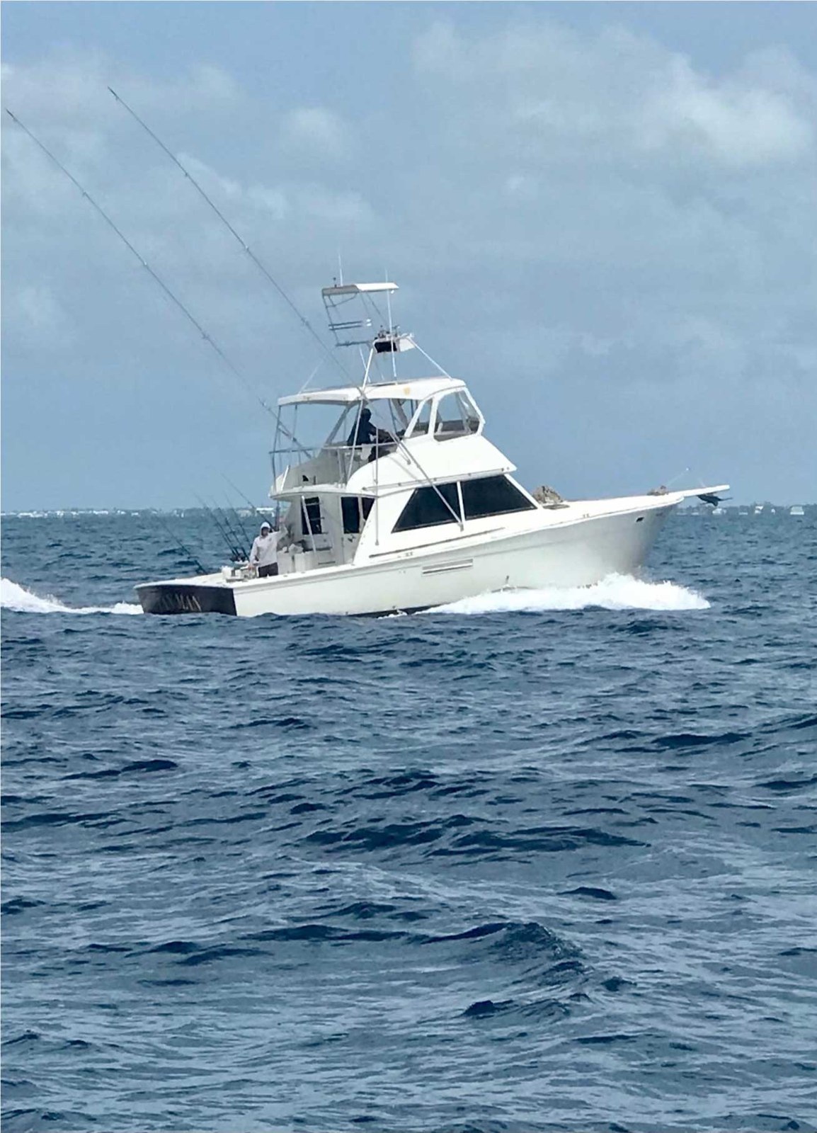Tan Man sportfishing boat running across open water
