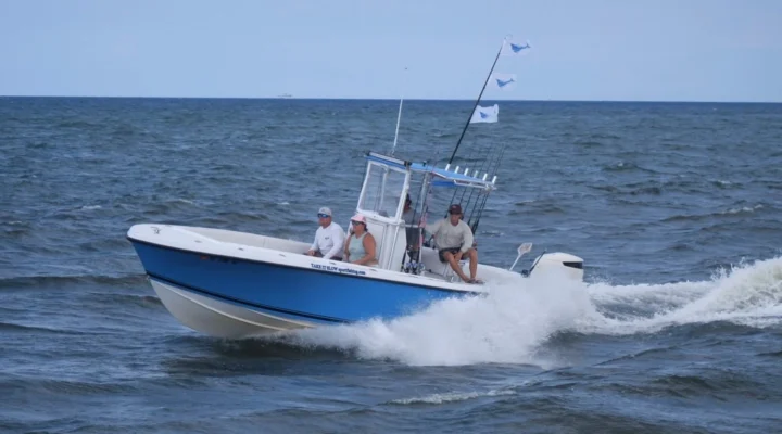The Take It Slow center console running across coastal water