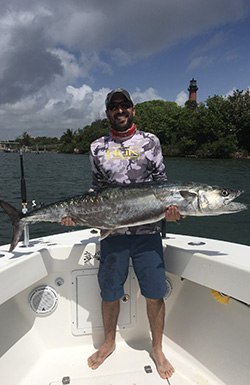 TomCat Sportfishing guest holding a king mackerel