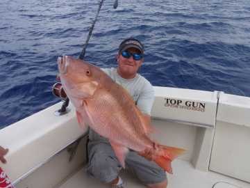 Top Gun angler holding a snapper