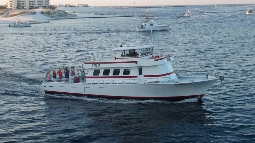 TradeWinds white and red fishing boat underway with passengers aboard