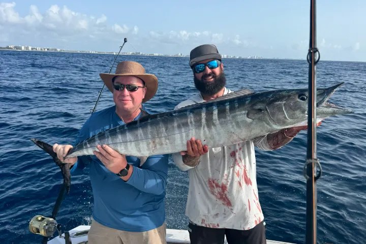 Two anglers displaying wahoo with RingMaster Charters