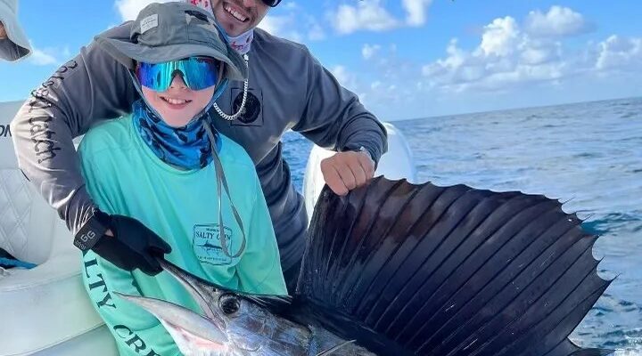 Uno Mas Charters anglers displaying a sailfish