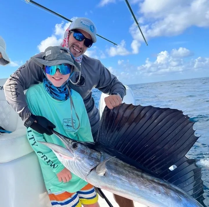 Uno Mas Charters anglers displaying a sailfish