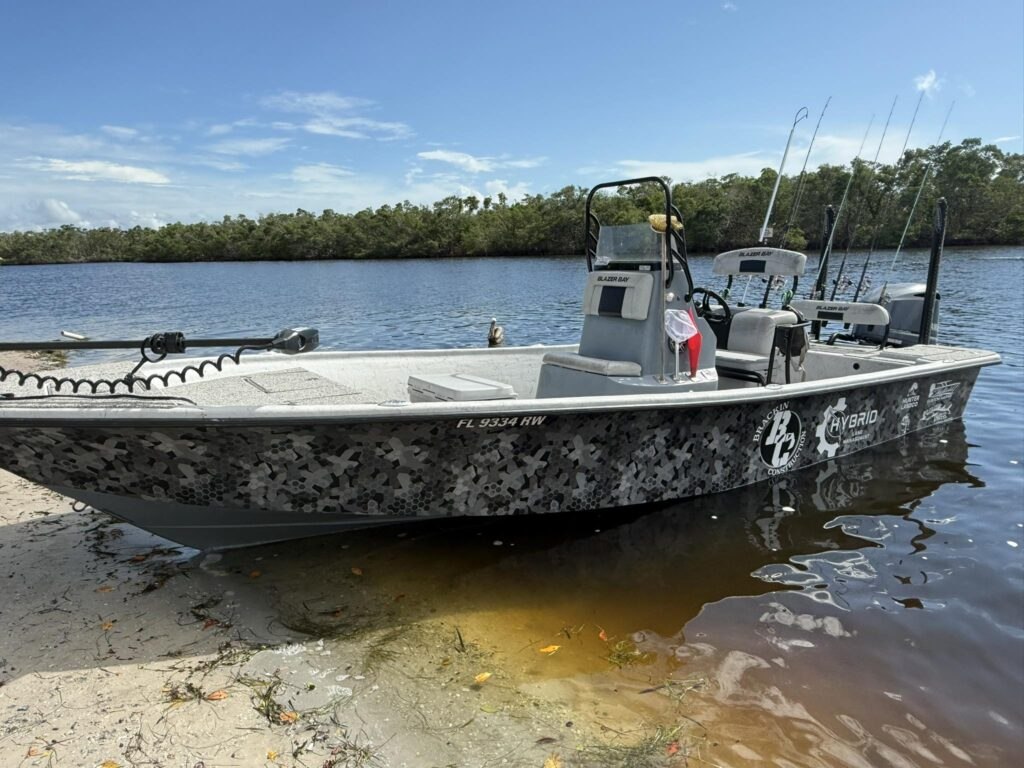 Unreel Fishing Charters bay boat resting beside the shoreline