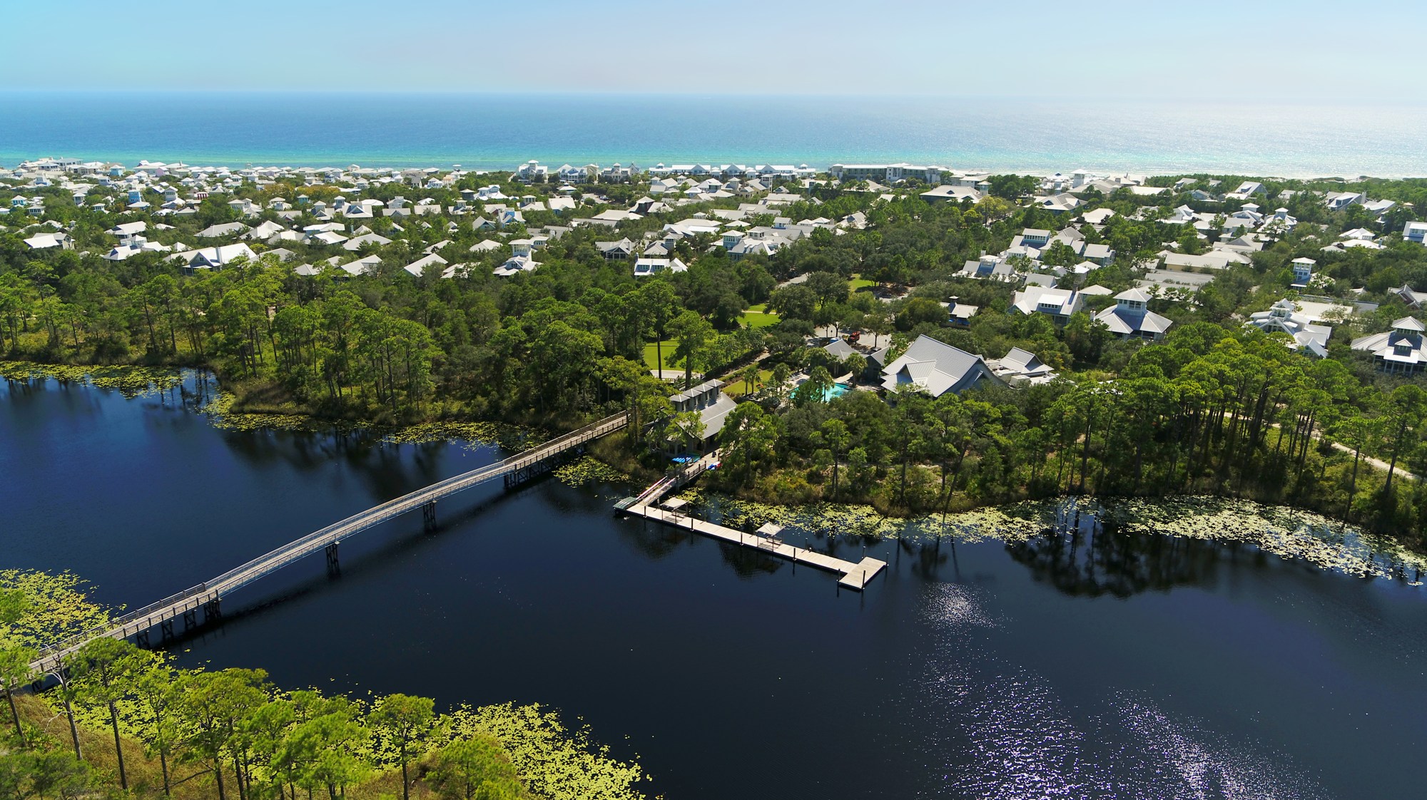 Aerial view of WaterColor coastal lake, bridge and neighborhood