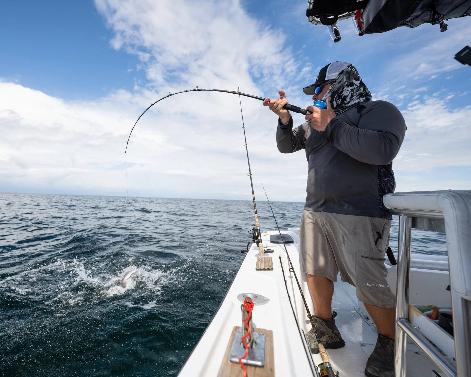 Wild Mullet Charters angler fighting a fish with a bent rod