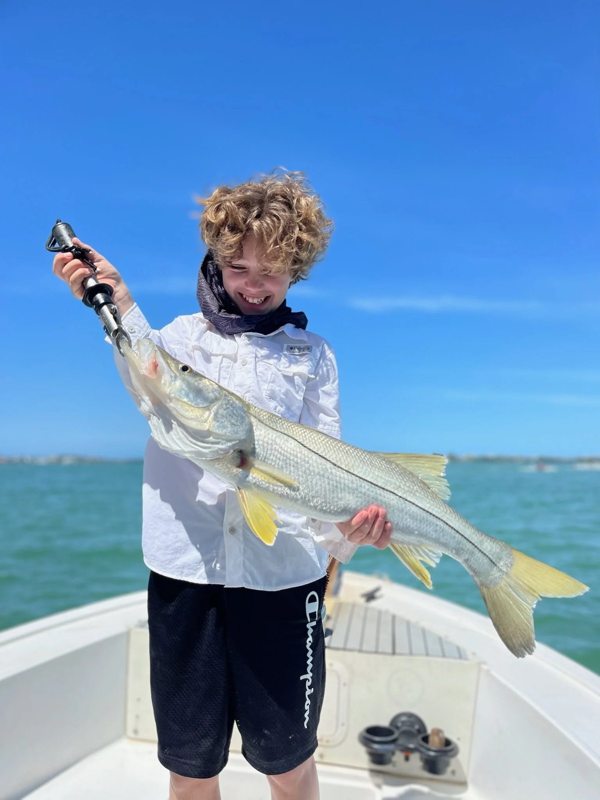 Wild Mullet Charters young angler holding a snook