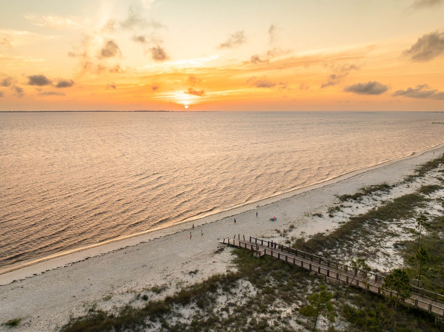 Aerial sunset view of WindMark Beach shoreline and beach walkway