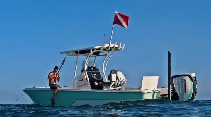 Wrecked Charters center-console boat in open water with a dive flag raised