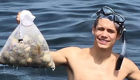 YKnotFish snorkeler holding a bag of scallops