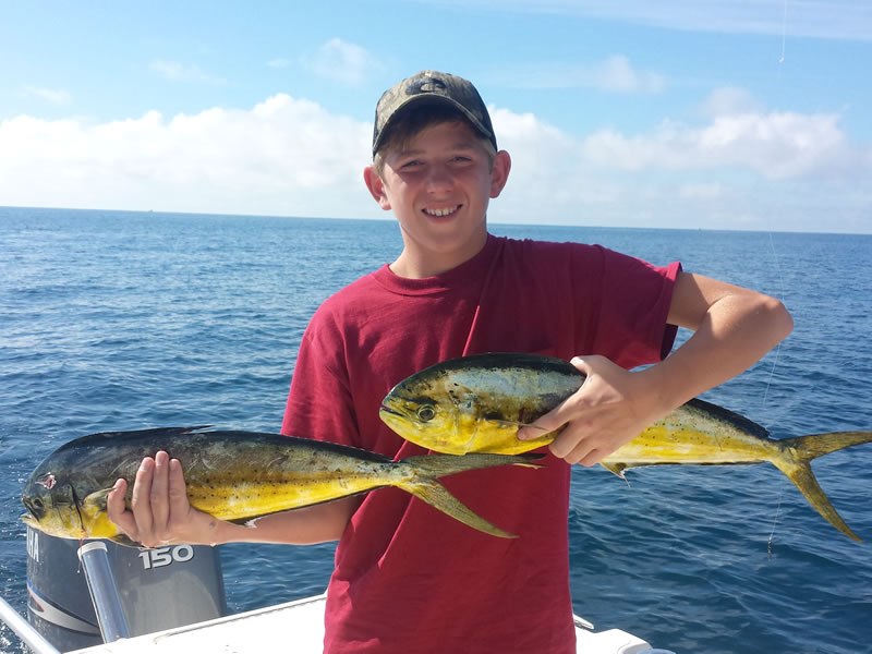 Young angler holding mahi mahi on Double Time